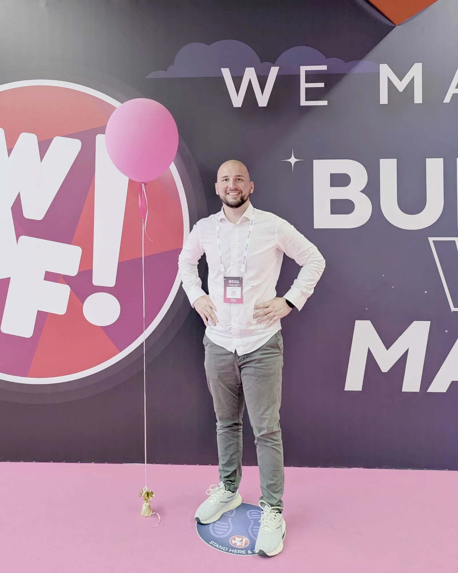 Matteo Fabrizi standing in front of the WMF branded wall at the Bologna fair.